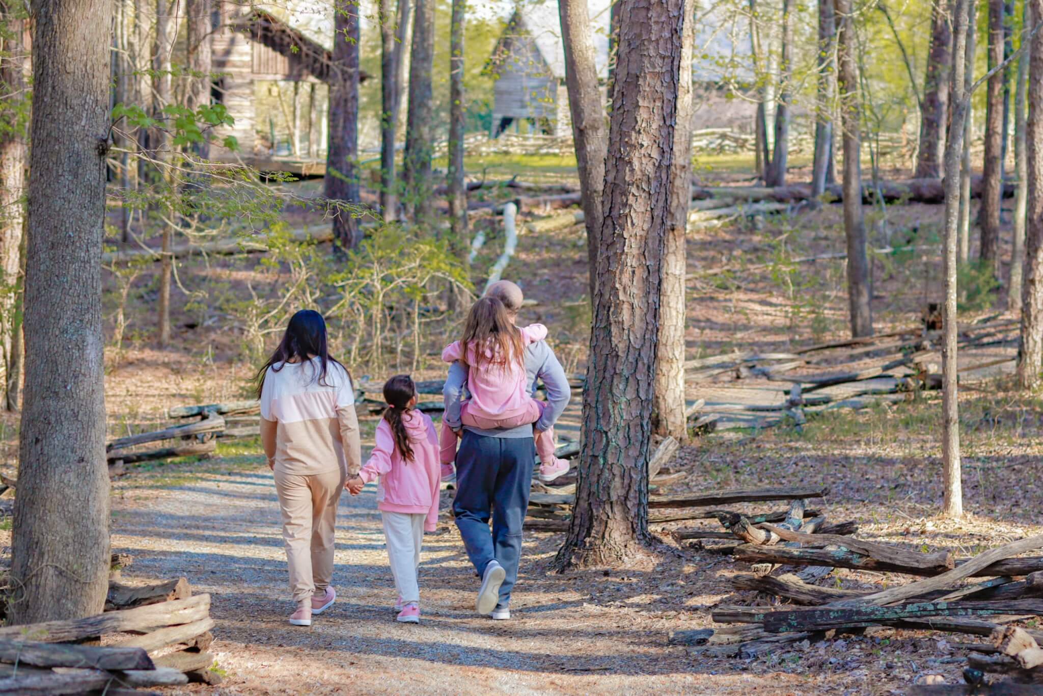 Winter Hikes in the OED Family walking along trail surrounded by trees.