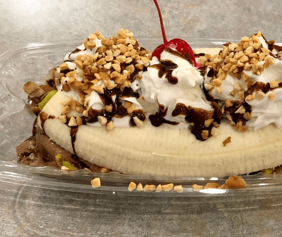Must Try Sweet Treats in The Olde English District Classic banana split with three scoops of ice cream and toppings.